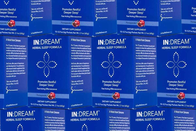 Multiple boxes of IN DREAM Herbal Sleep Formula on a blue background