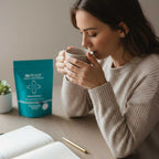 Woman drinking from a mug with IN PEACE product in the background