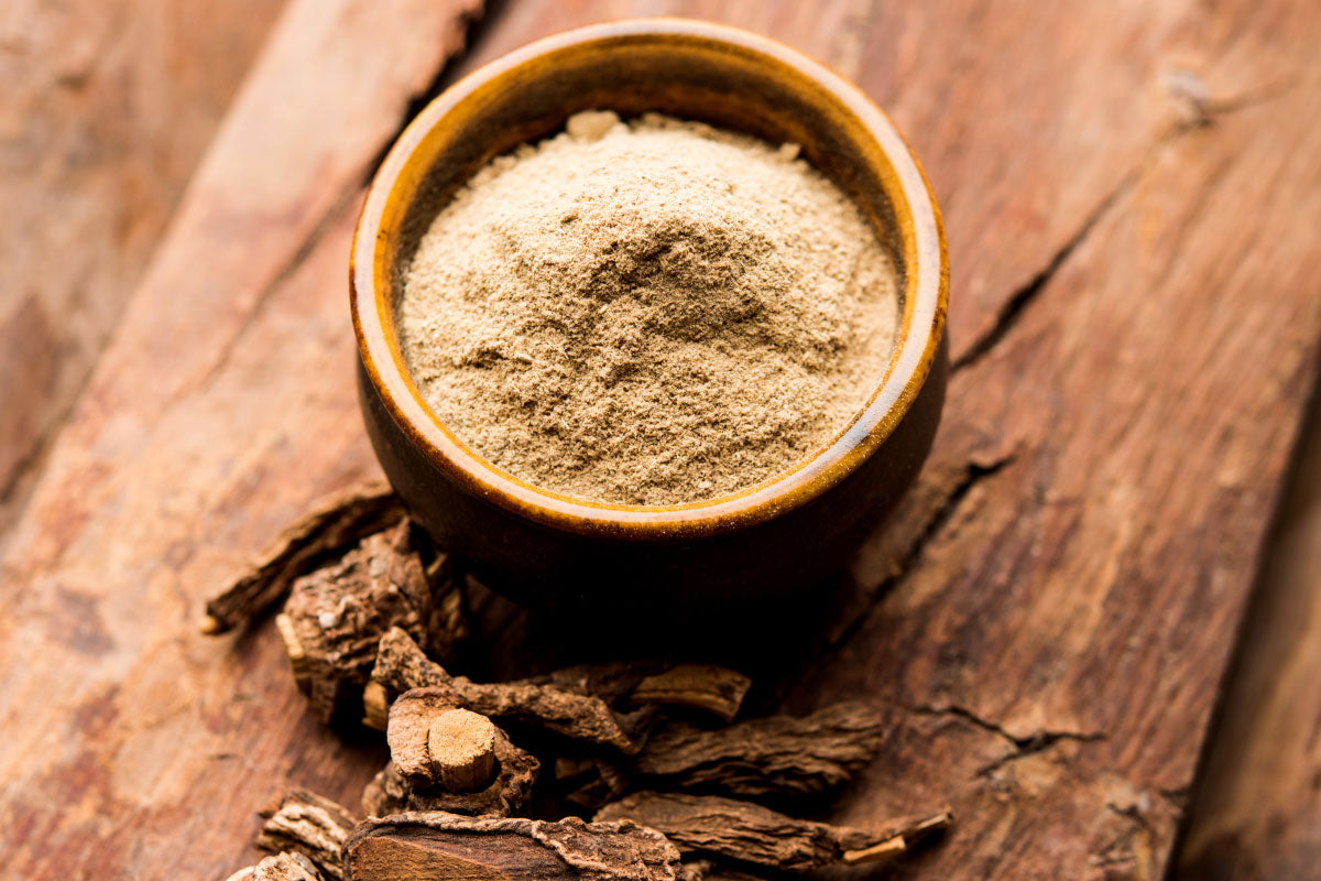 Herbal powder in a wooden bowl on a wooden surface