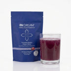 IN:DREAM herbal sleep supplement package with a glass of red liquid on a white background