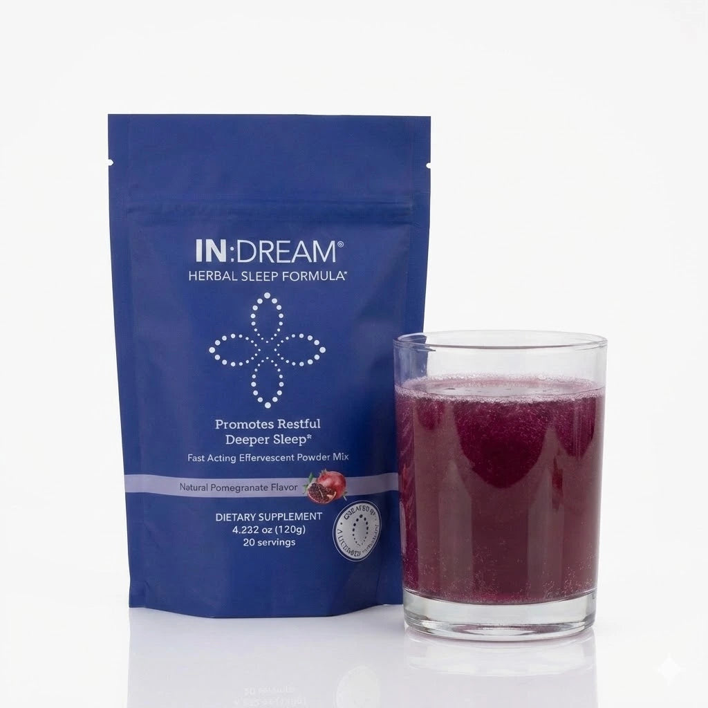 IN:DREAM herbal sleep supplement package with a glass of red liquid on a white background